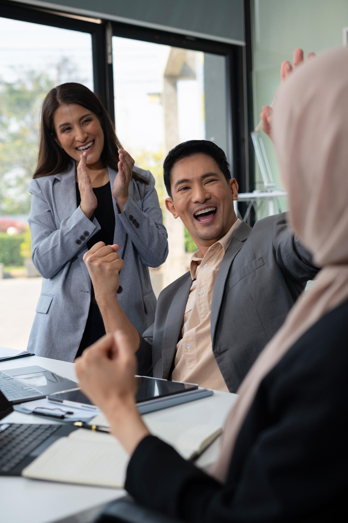 Professional digital marketing team collaborating on strategy in modern office Malaysia